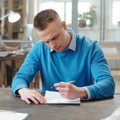 man writing on paper picture