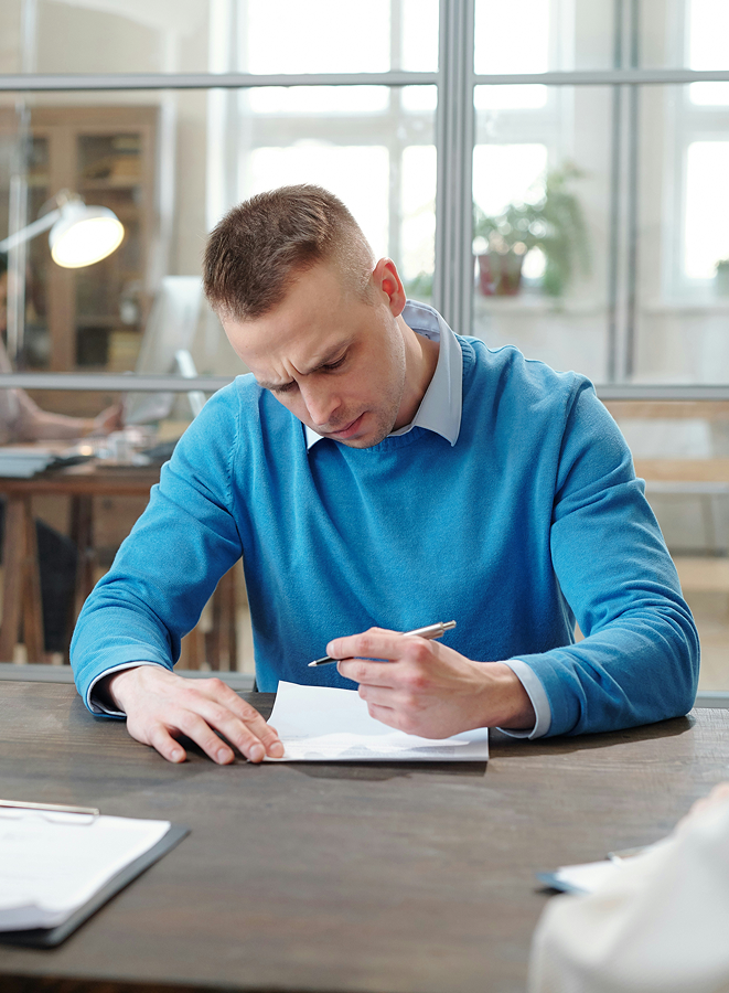 man writing on paper picture