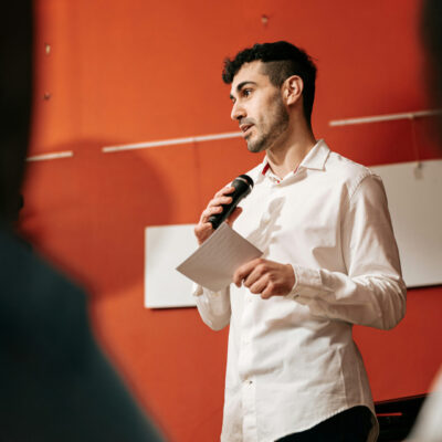 man talking into microphone picture