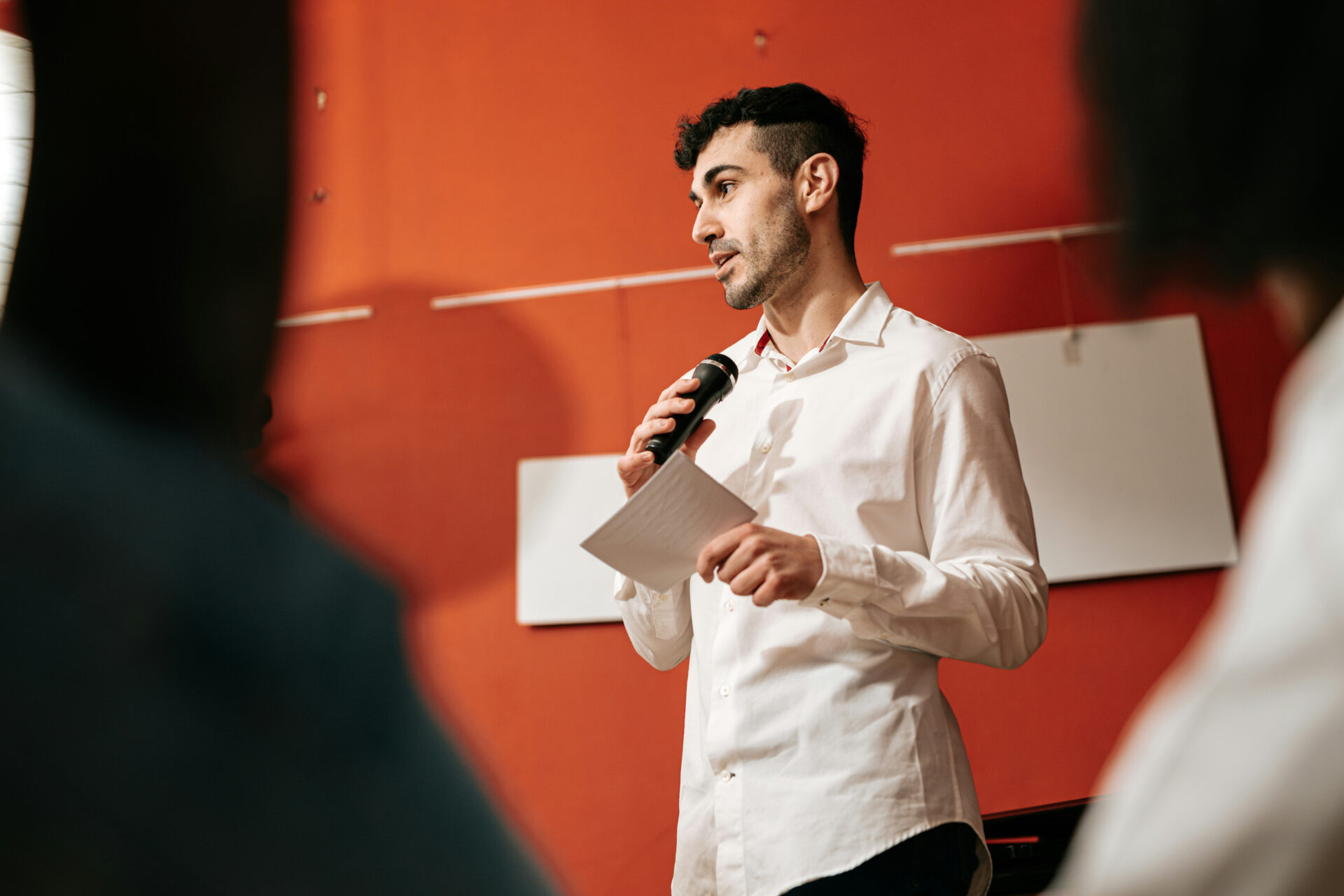 man talking into microphone picture