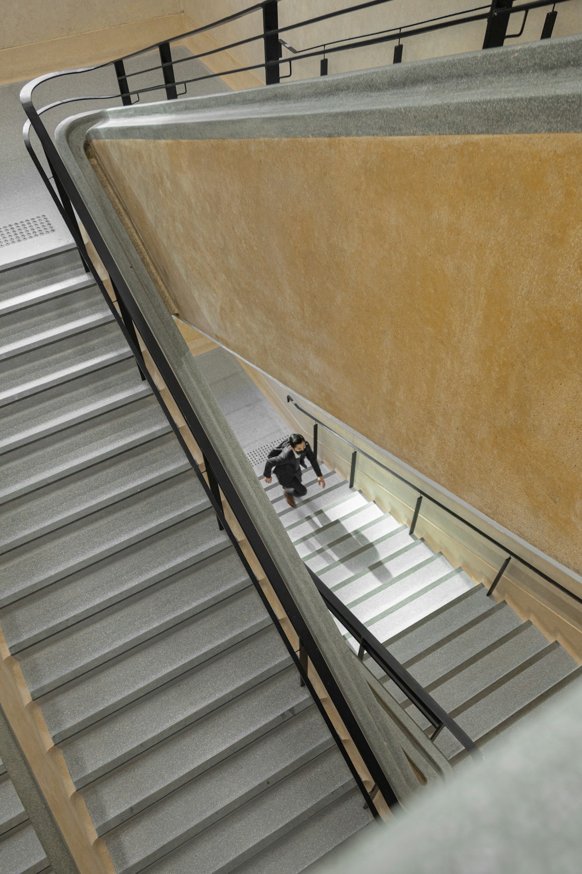 man walking up stairwell picture