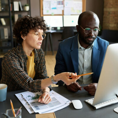 man and woman looking at computer picture